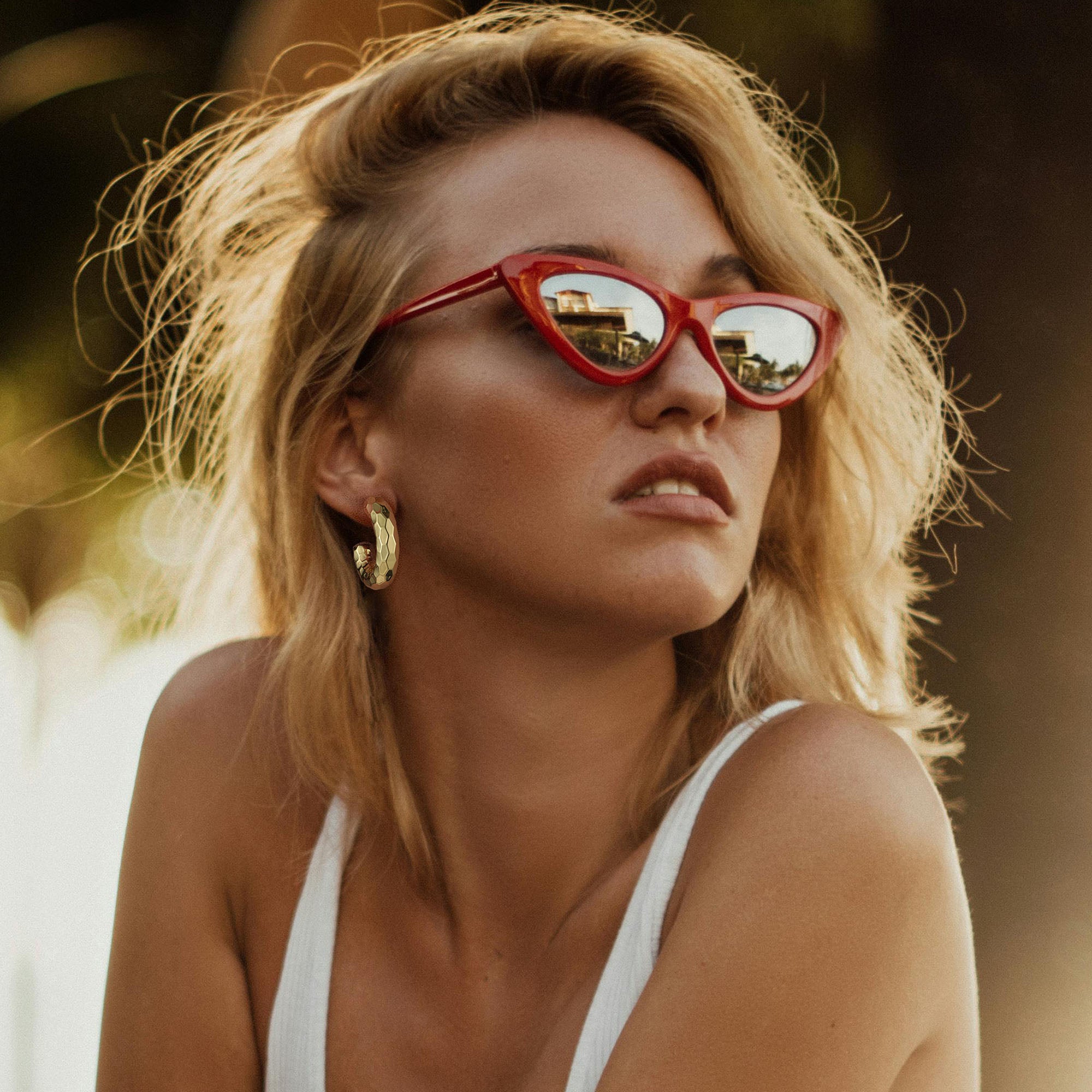 Golden-colored C-shaped earrings with various textures