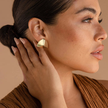 Golden, triangular protruding earrings